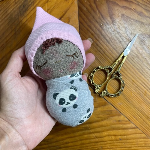 tiny swaddled doll